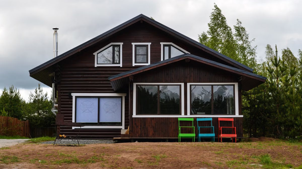 A rustic wooden house amidst nature, ideal for serene countryside retreats.